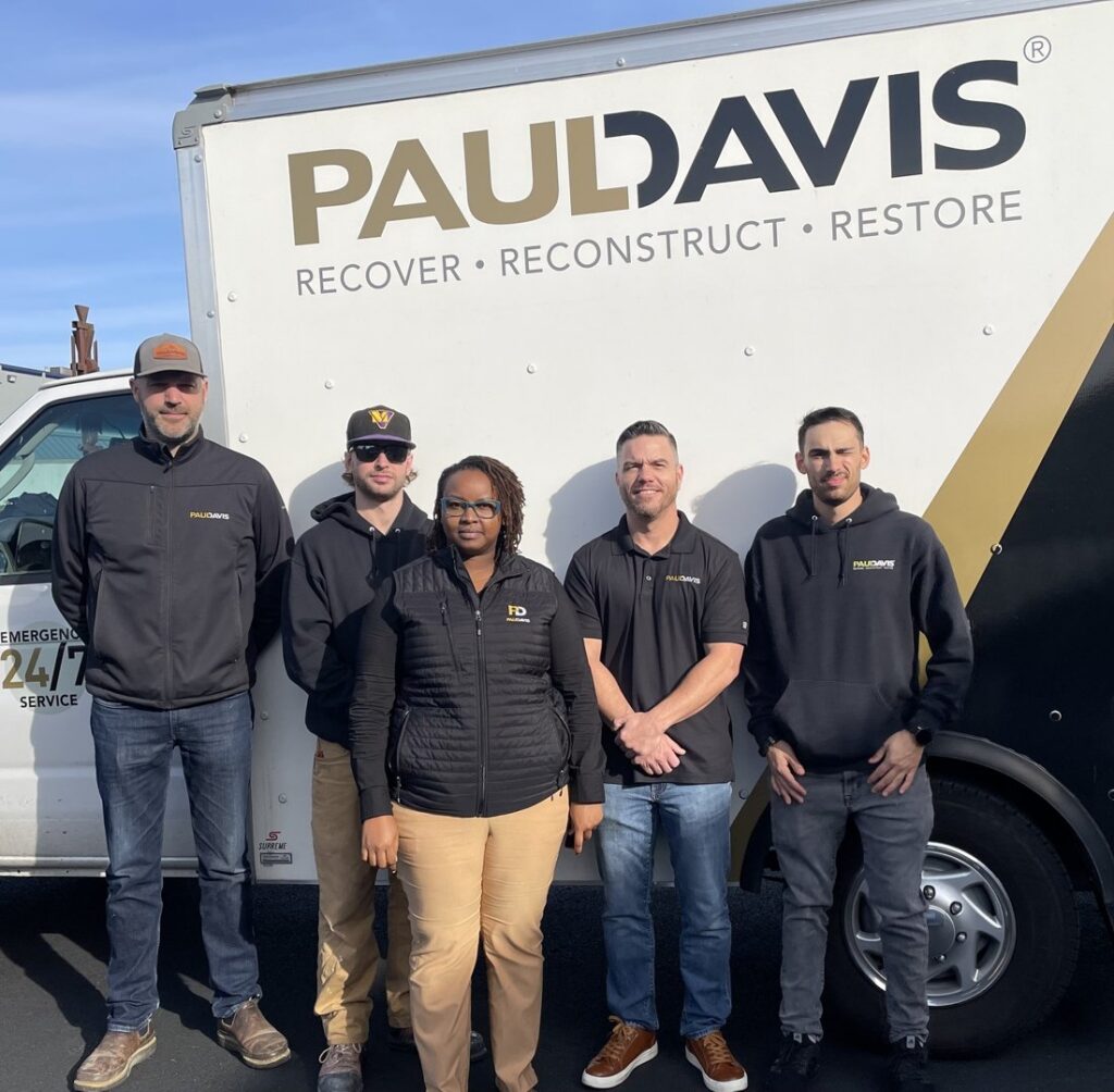 Paul Davis Restoration of Southeast Puget Sound team members standing in front of branded emergency restoration truck providing water, fire, mold, and storm damage restoration services in Washington